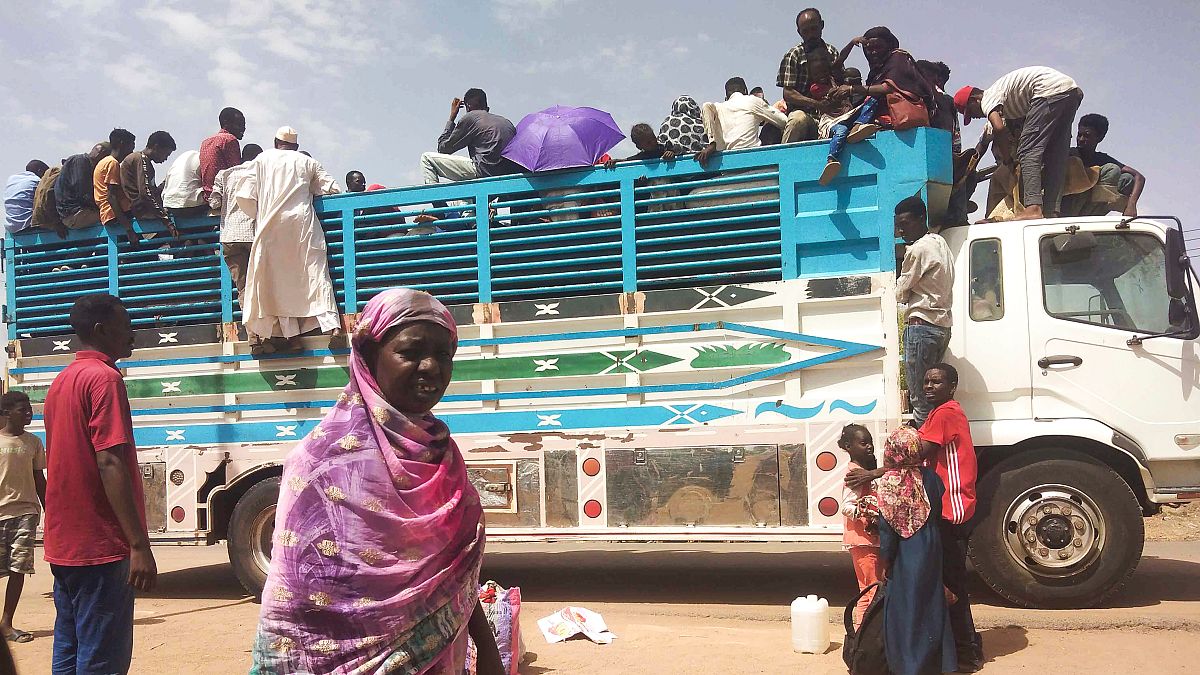 People board a truck as they leave Khartoum, Sudan, on June 19, 2023.