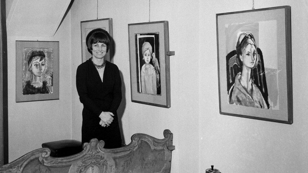 Artist Francois Gilot poses with her work at a personal art exhibition in Milan, Dec. 21, 1965.