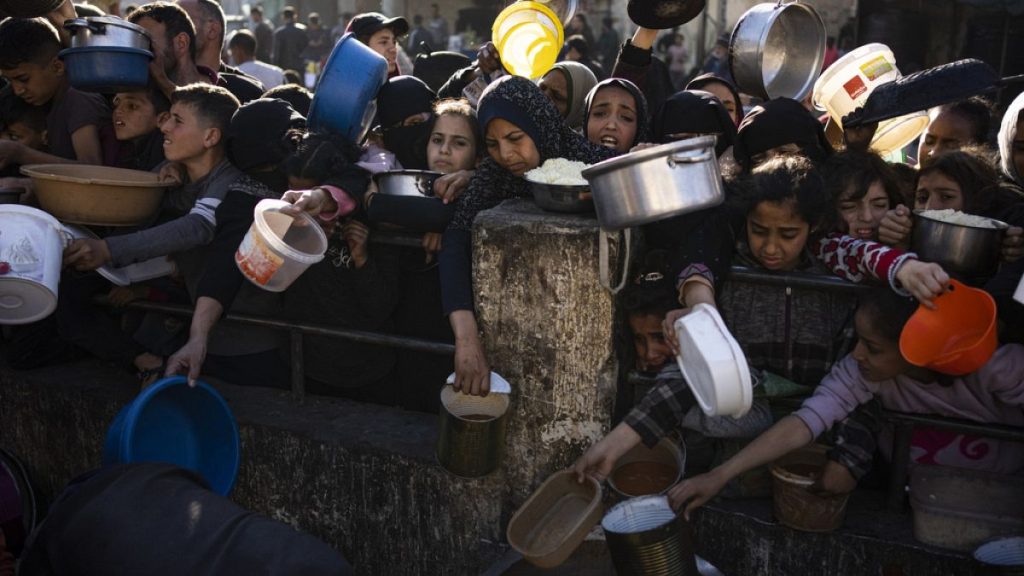 Palestinians line up for a free meal in Rafah, Gaza Strip, on Tuesday, March 12, 2024.