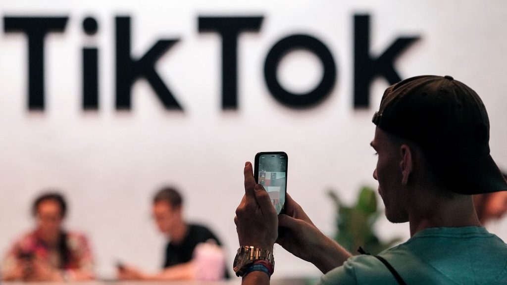 A visitor takes a photo at the TikTok stand at the Gamescom gaming fair in Cologne, Germany.