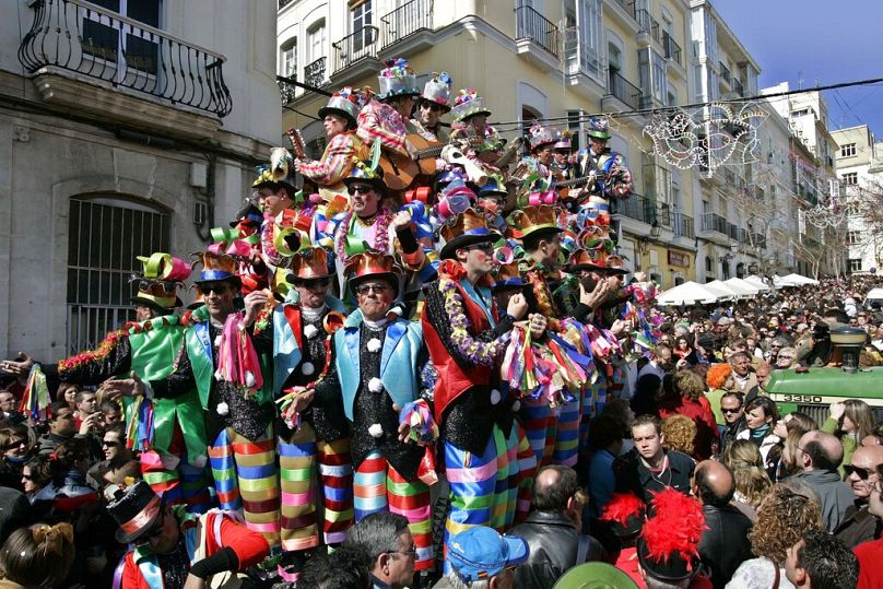Un char de fêtards du carnaval est remorqué le long d'une rue bondée de Cadix, dans le sud de l'Espagne.