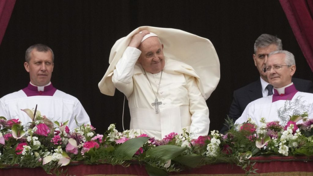 Pope Francis smiles from the central balcony of the St. Peter