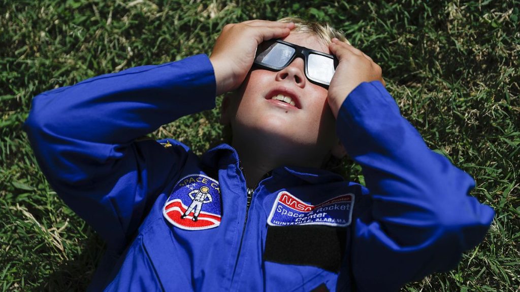 Tyler Hanson, of Fort Rucker, Ala., watches the sun moments before the total eclipse, Monday, Aug. 21, 2017, in Nashville, Tenn.