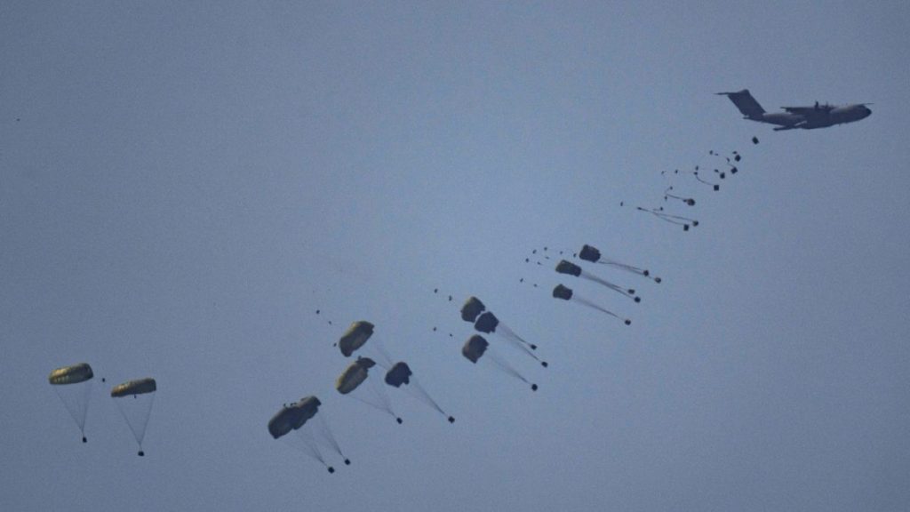 An aircraft airdrops humanitarian aid over Gaza the northern Gaza Strip, as seen from southern Israel, Friday, March 8, 2024.