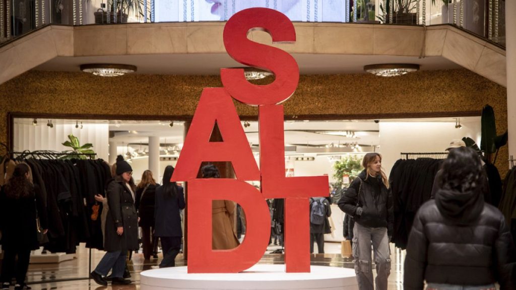 People walk around in a shop in the heart of Milan, Italy, during the January sales