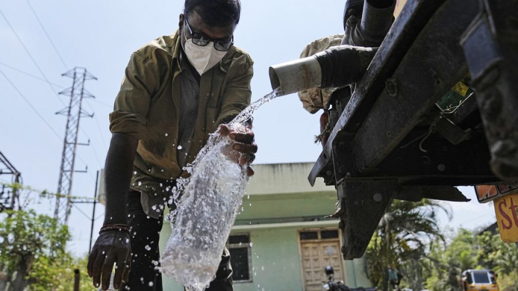 Man collects water from a pump