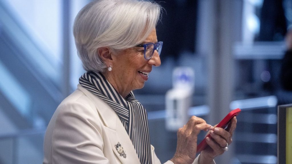 President of European Central Bank, Christine Lagarde, holds a mobile device prior to a press conference after an ECB