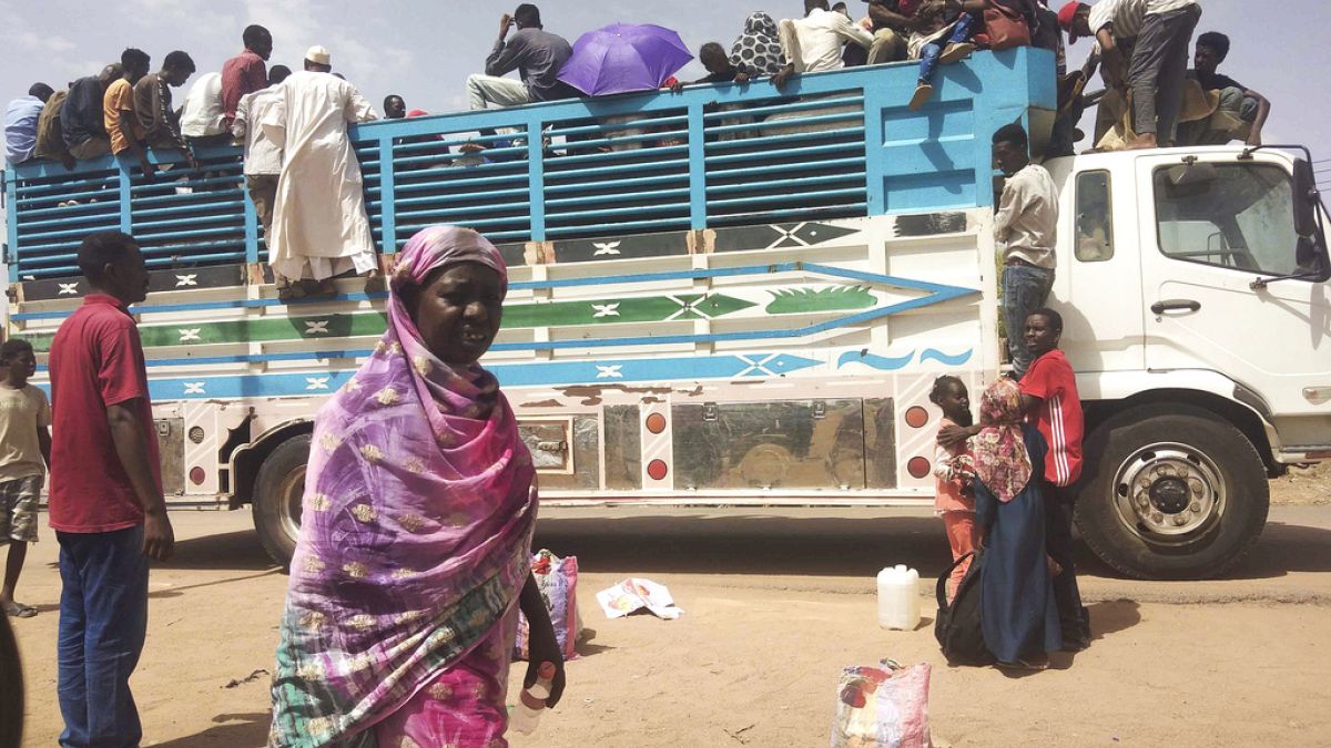 People board a truck as they leave Khartoum, Sudan, on June 19, 2023