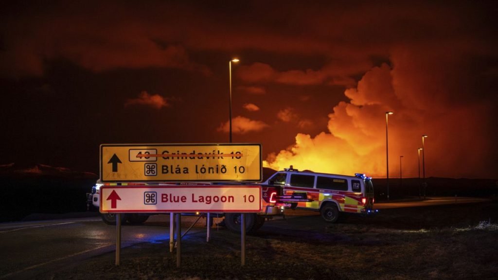 Emergency vehicles are stationed on a road leading to volcanic activity between Hagafell and Stóri-Skógfell