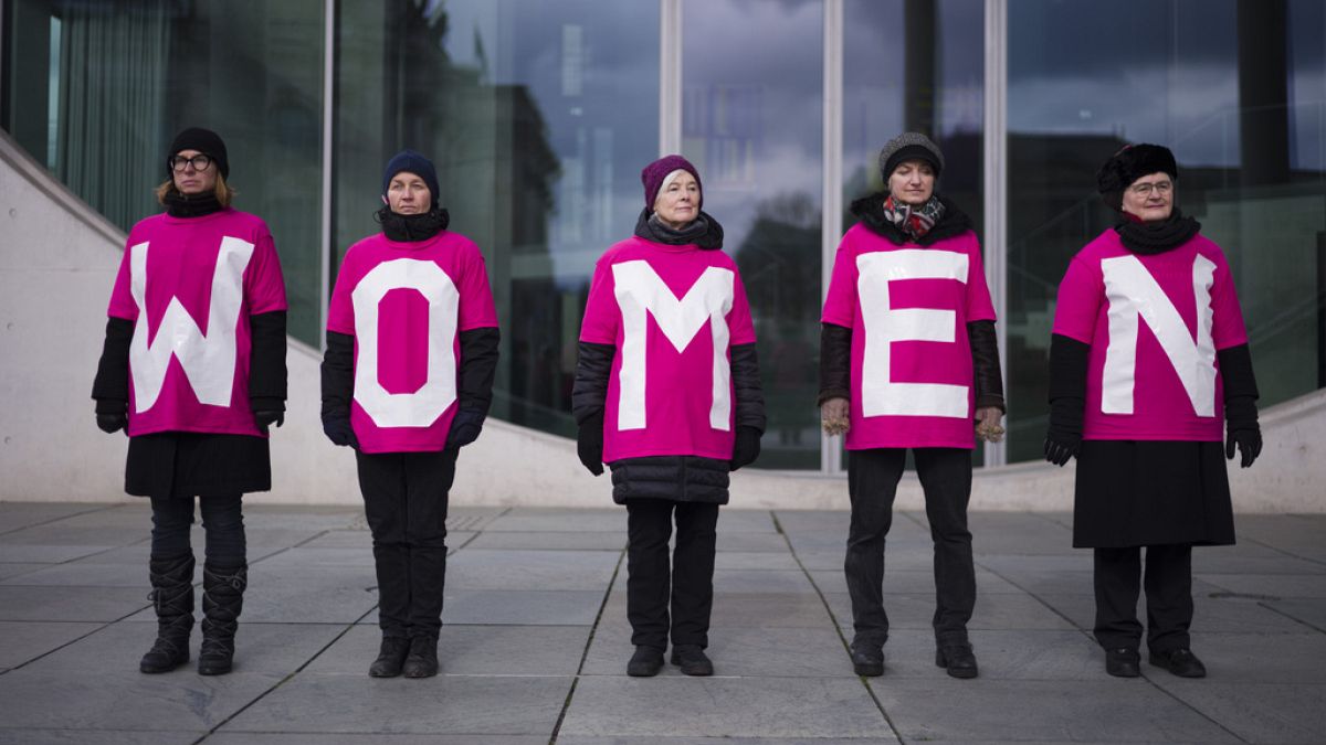 Women attend a protest marking International Women