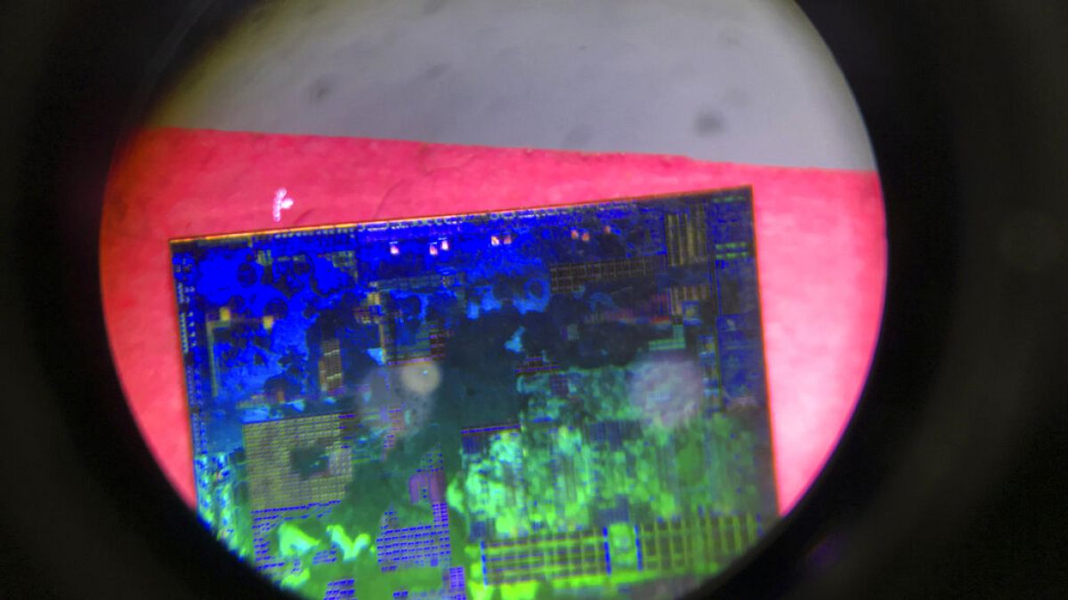 A Chinese microchip is seen through a microscope set up at the booth for Tsinghua Unigroup project at the China Beijing International High-tech Expo in Beijing on May 17, 2018