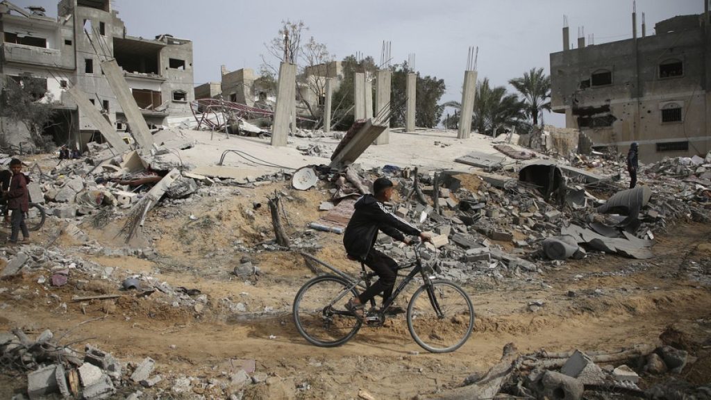 Palestinians inspect the ruins of a residential building for the Abu Muammar family after an Israeli airstrike in Rafah, southern Gaza Strip, Friday, March 29, 2024.