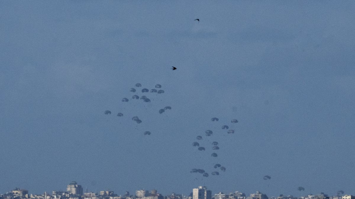 Parachutes drop supplies into the northern Gaza Strip, as seen from southern Israel, Thursday, March 7