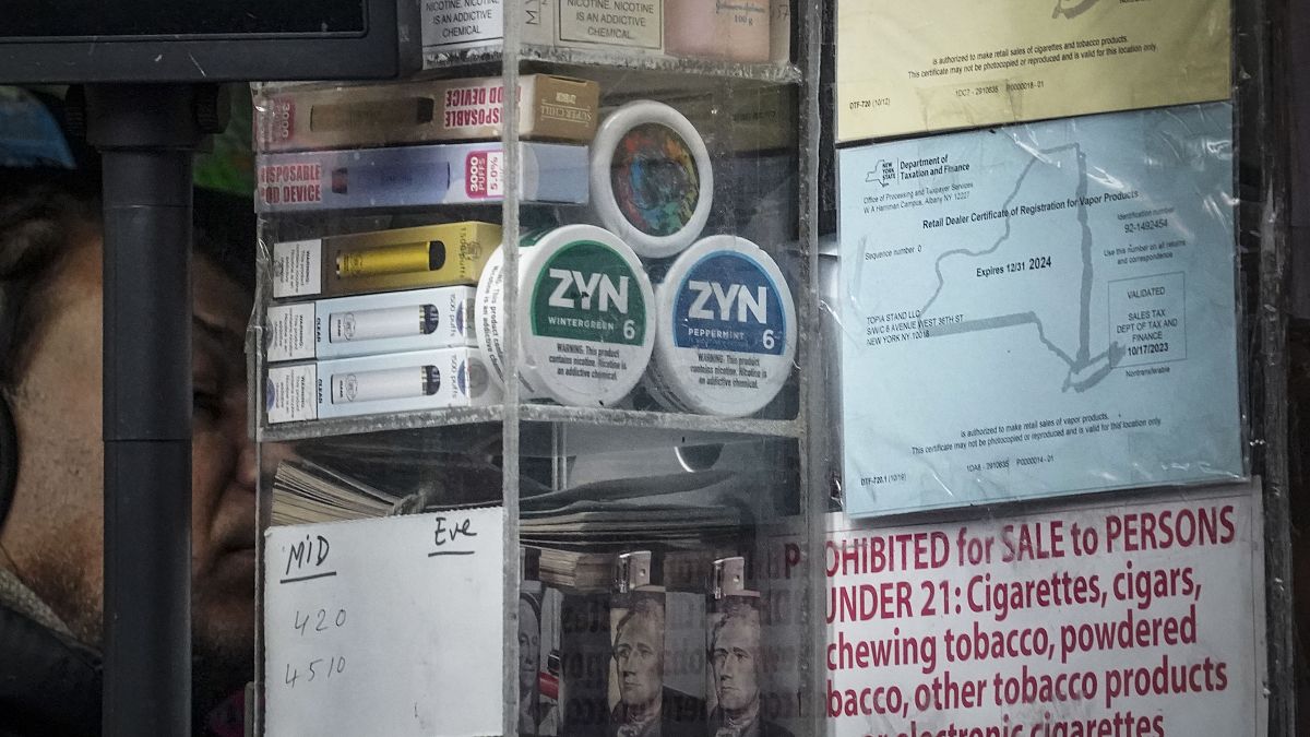 Containers of Zyn, a Phillip Morris smokeless nicotine pouch, is stacked for sale at a newsstand.