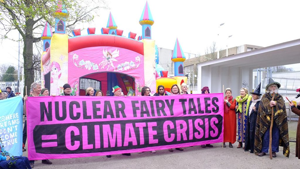 Anti-nuclear campaigners stage a protest as government leaders gather in Brussels to promote a global nuclear revival.