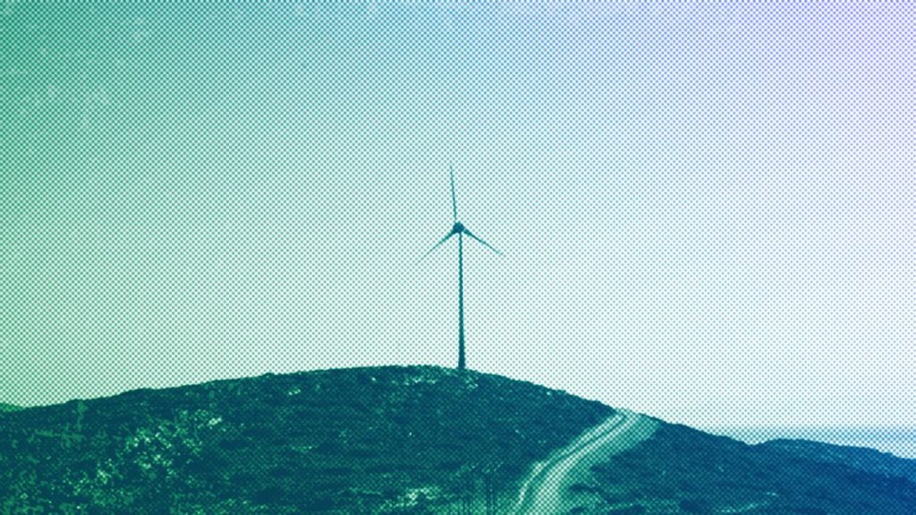 A road leads past a wind turbine stands on the Aegean island of Tilos, August 2018