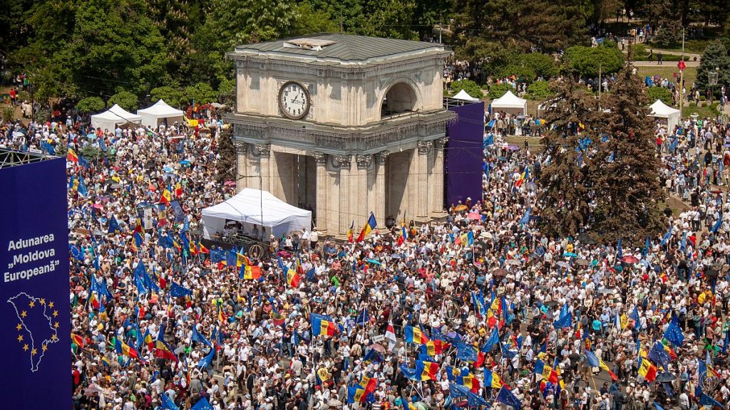 FILE - People holding European Union and Moldovan flags fill the Great National Assembly Square in Chisinau, Moldova, Sunday, May 21, 2023.