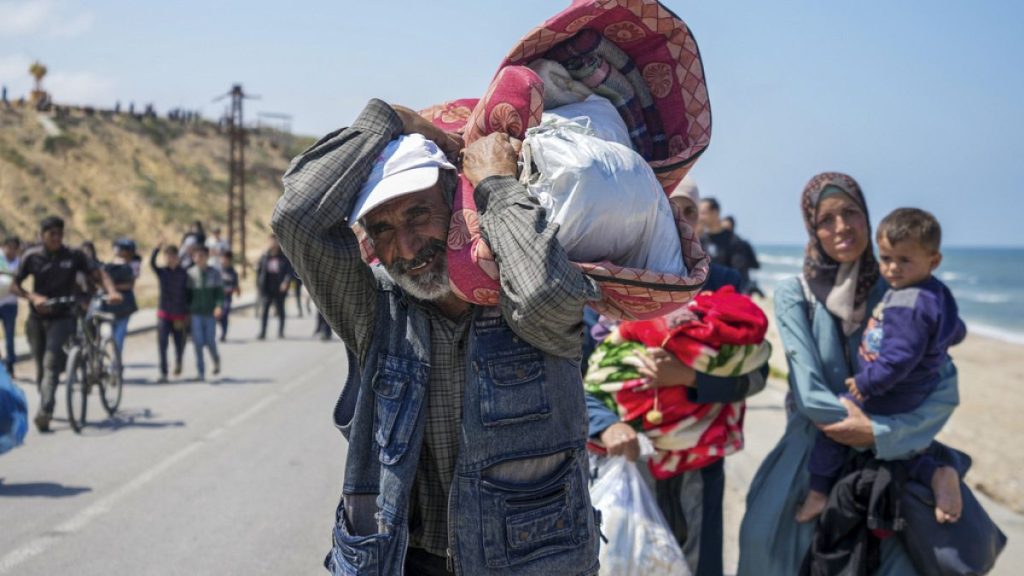 Displaced Palestinians trying to walk back from central Gaza Strip to northern Gaza Strip , Sunday, April 14, 2024