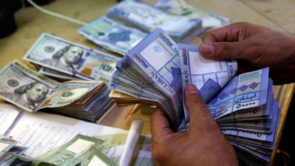 A man counts Lebanese pounds at an exchange shop, in Beirut.