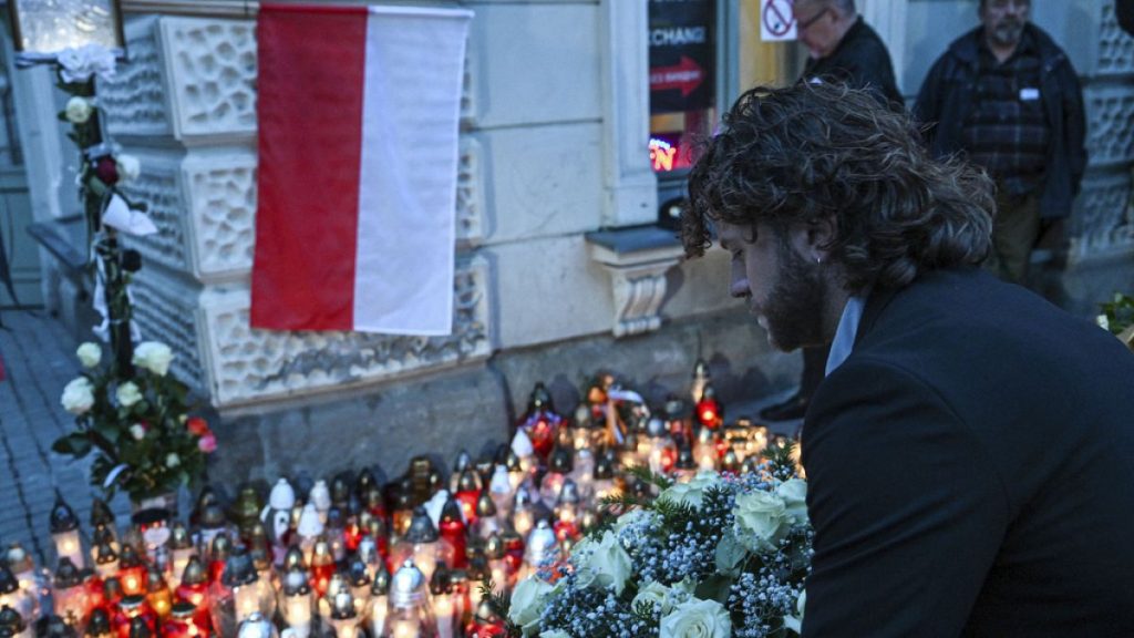 Friends and residents gather to place candles and flowers in honour of Damian Soból, a Polish food aid worker who was killed with six other World Central Kitchen workers