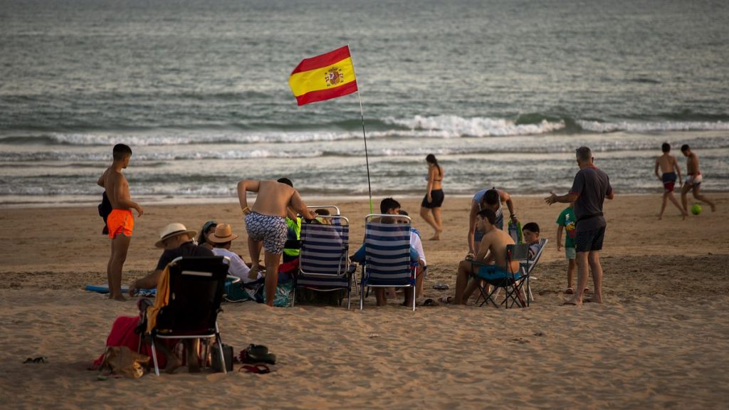 Bathers enjoy the beach in Barbate in southern Spain