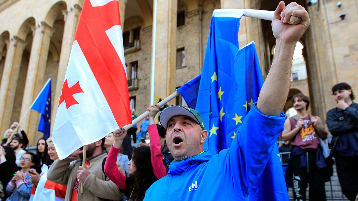 Protesters gather outside the parliament building in Tbilisi.