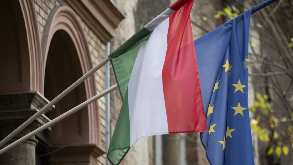 A Hungarian and a European Union flag is seen on a building in downtown Budapest, Hungary, Monday, Nov. 20, 2023 (AP Photo/Denes Erdos)