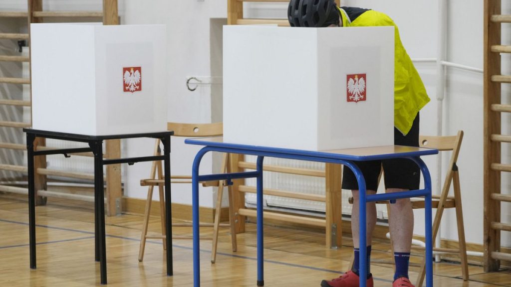 A man casts his ballot during local elections in Warsaw, Poland