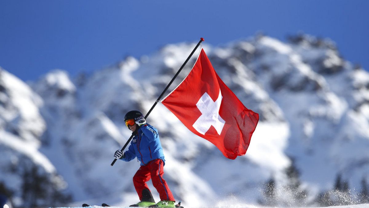 A young Swiss supporter hold a Swiss banner prior to the start of alpine ski, women