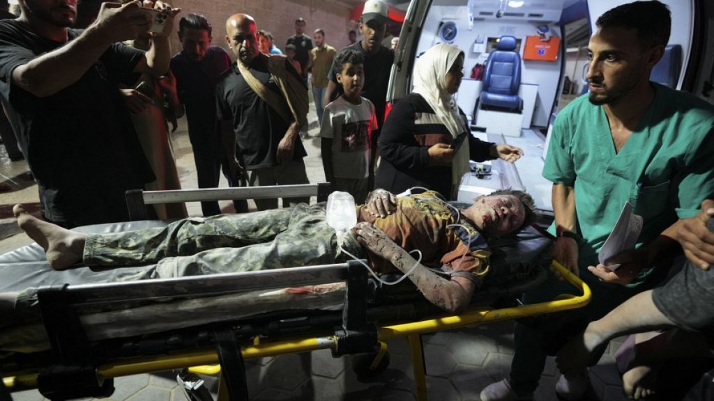 A Palestinian wounded in an Israeli bombardment on the Gaza Strip is brought to Al Aqsa hospital in Deir al Balah, central Gaza Strip, on Sunday, May 26, 2024.