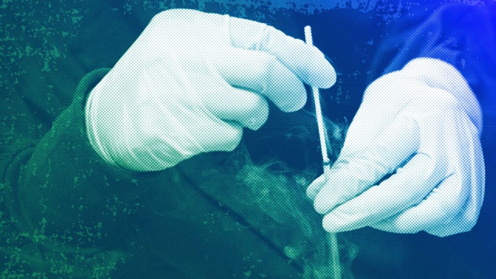 A medical professional removes the cryostorage sheath from a container for an embryo at a laboratory in Shenzhen, October 2018