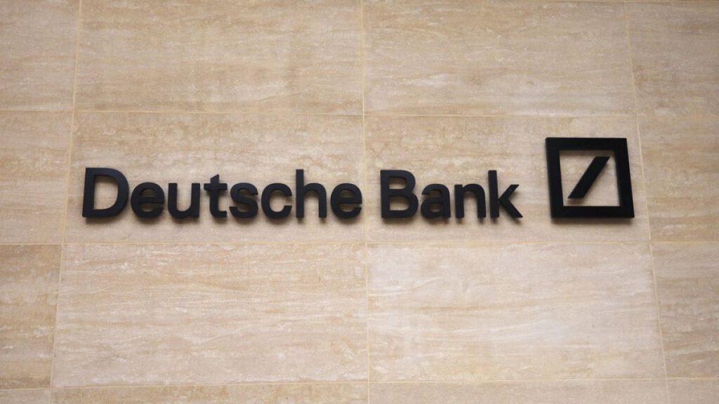 this July 8, 2019 file photo, a Deutsche Bank sign and logo are seen on the outside of their building in London.