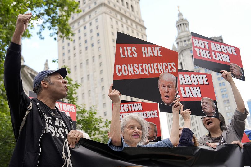 Les gens réagissent au verdict de culpabilité prononcé contre l'ancien président Donald Trump devant le tribunal pénal de Manhattan, le 30 mai 2024.