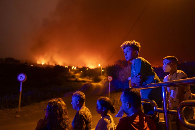 Les habitants sont bloqués par la police alors qu'ils tentent d'atteindre leurs maisons dans le village de Benijos alors qu'un incendie de forêt progresse à La Orotava à Tenerife, août 2023.