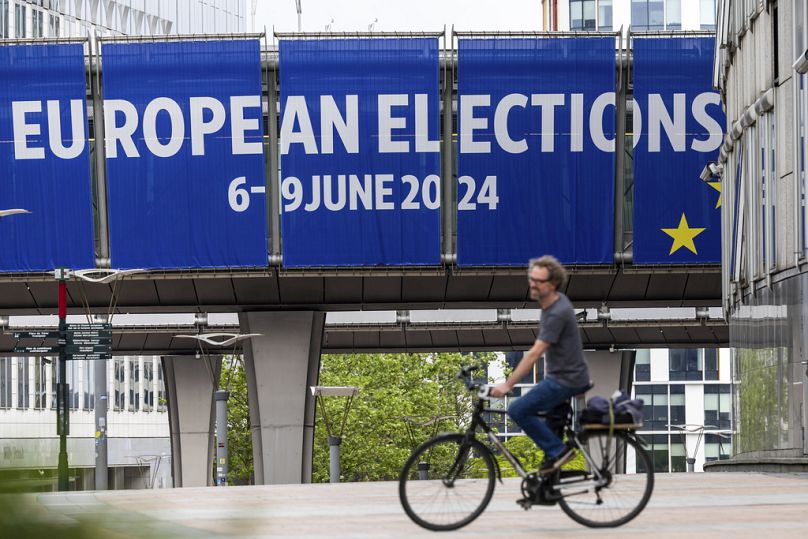Un homme fait du vélo devant le Parlement européen, mai 2024