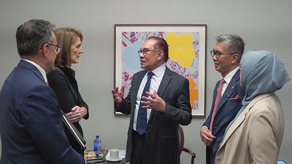 Malaysian Prime Minister Anwar Ibrahim, center, talks with Ruth Porat, second left, Alphabet Inc.
