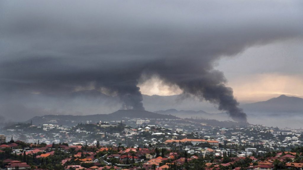 Smoke rises during protests in Noumea, New Caledonia, Wednesday May 15, 2024.