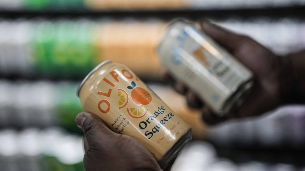 Cans of Olipop, a soda containing botanicals, plant fibers, and prebiotics, are shown at a Kroger supermarket, Friday, April 12, 2024, in Marietta, Ga.