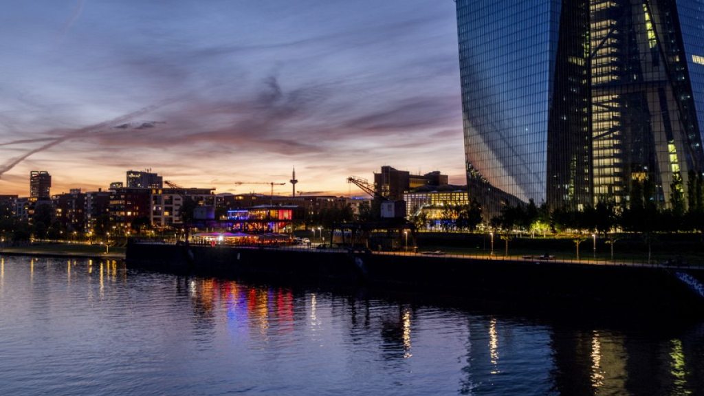 Colourful lights burn in the window of a restaurant near the European Central Bank, right, in Frankfurt, Germany, late Friday, May 3, 2024.