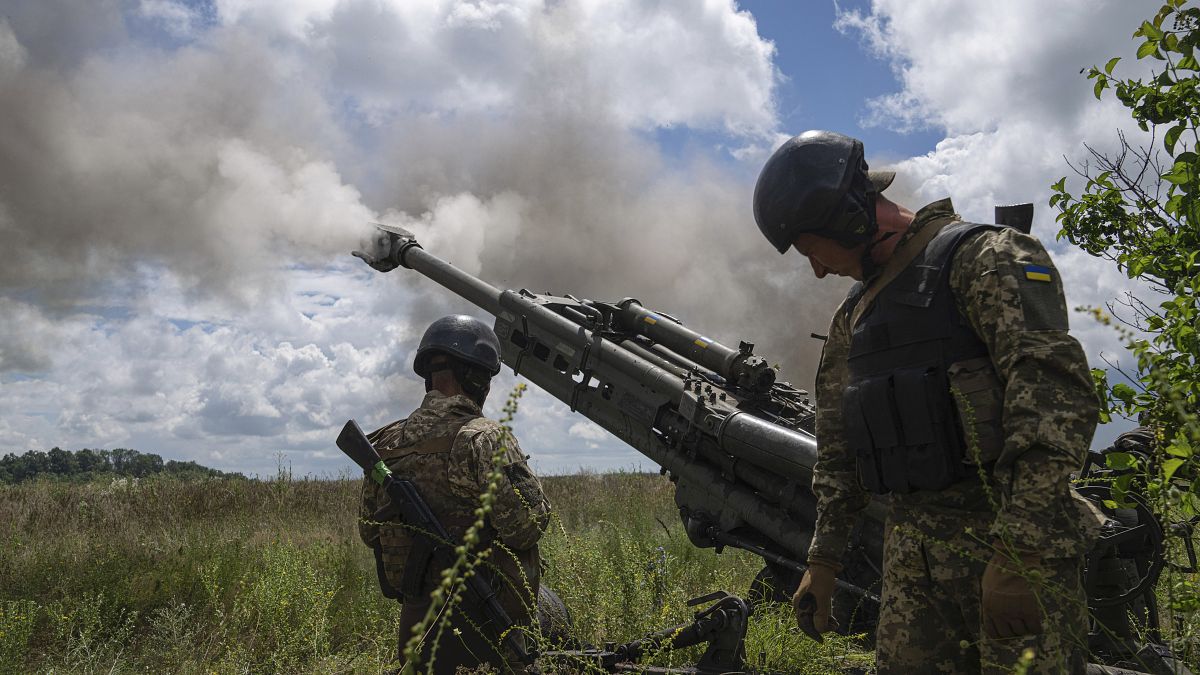 FILE - Ukrainian servicemen fire at Russian positions from a U.S.- supplied M777 howitzer in Kharkiv region, Ukraine, on Thursday, July 14, 2022.