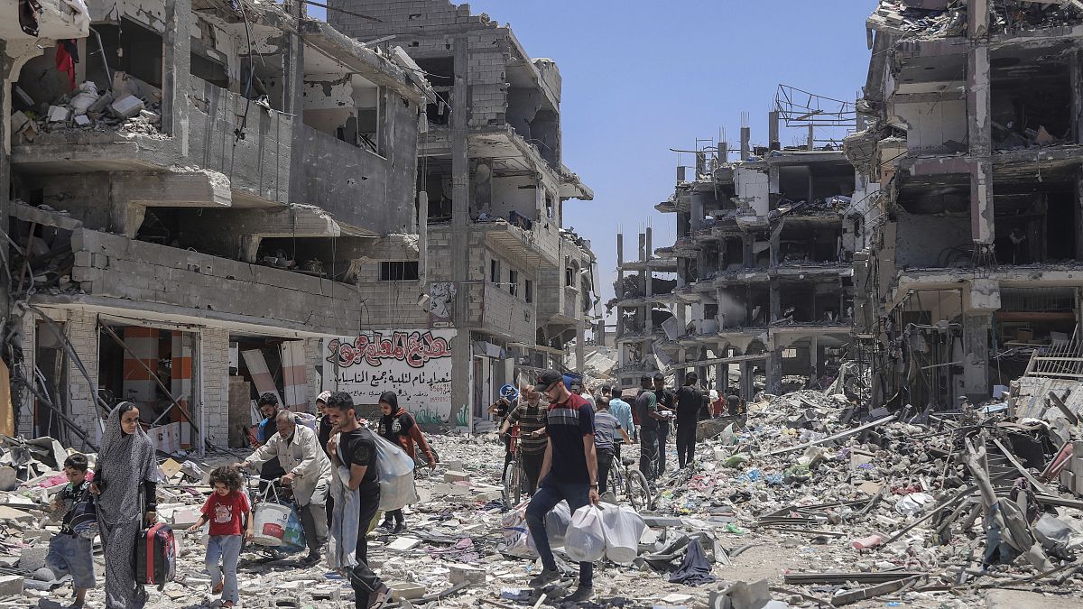 Palestinians walk through the destruction in the wake of an Israeli air and ground offensive in Jabaliya, May 30, 2024