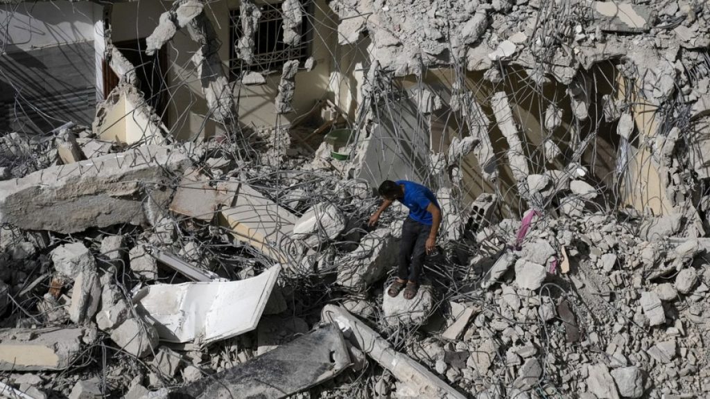 A Palestinian man inspects the damage to a building after Israeli forces raided the West Bank city of Jenin, Thursday, May 23, 2024.