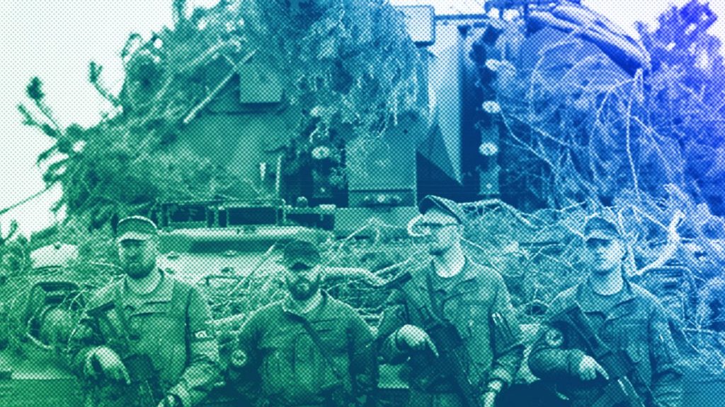 German Bundeswehr soldiers stand next to a self-propelled howitzer PzH 2000 of German Army at a training range in Pabrade, north of the capital Vilnius, May 2024