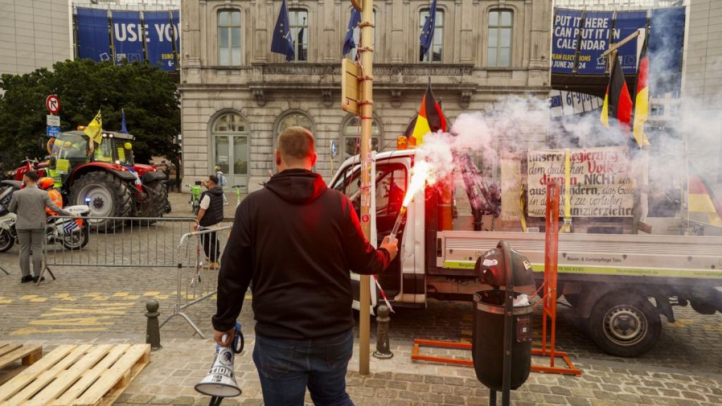 Farmers march with tractors during a protest outside the European Parliament in Brussels, 4 June 2024