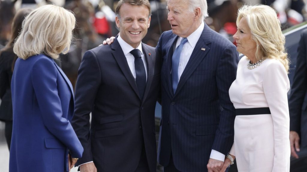 French President Emmanuel Macron, second left, his wife Brigitte Macron, left, welcome President Joe Biden and First Lady Jill Biden before a ceremony at the Arc de Triomphe,