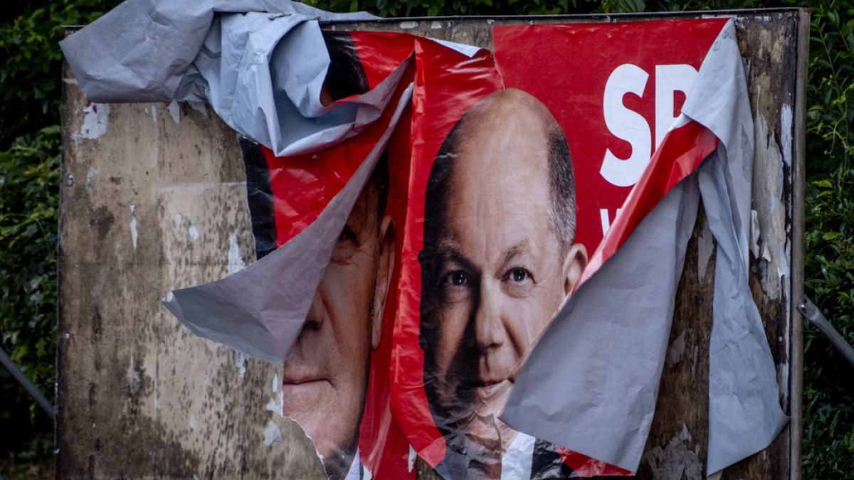 A damaged election poster shows German Chancellor Olaf Scholz in Frankfurt, Germany, Monday, June 10, 2024.