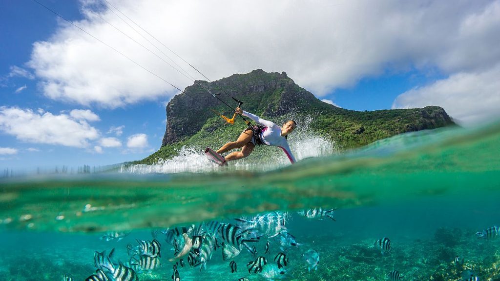 Girl kiting in the ocean