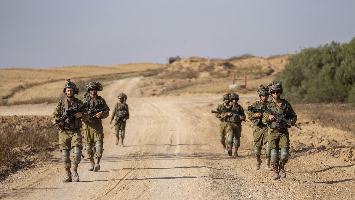 Israeli soldiers are seen near the Gaza Strip border in southern Israel, 13 June 2024