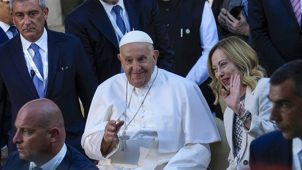 Pope Francis leaves with Italian Prime Minister Giorgia Meloni at the end of a group photo the G7 in Borgo Egnazia, June 14, 2024