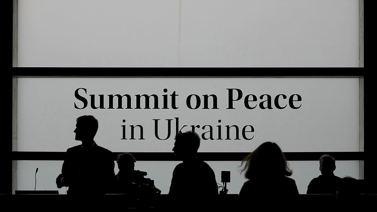 People walk in the media centre before the Ukraine peace summit in Switzerland, June 15, 2024